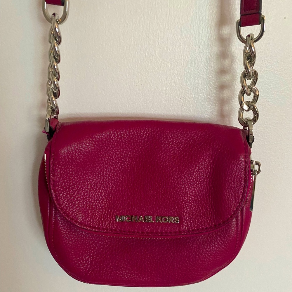 Vibrant pink cross body Michael Kors bag with silver chain accent